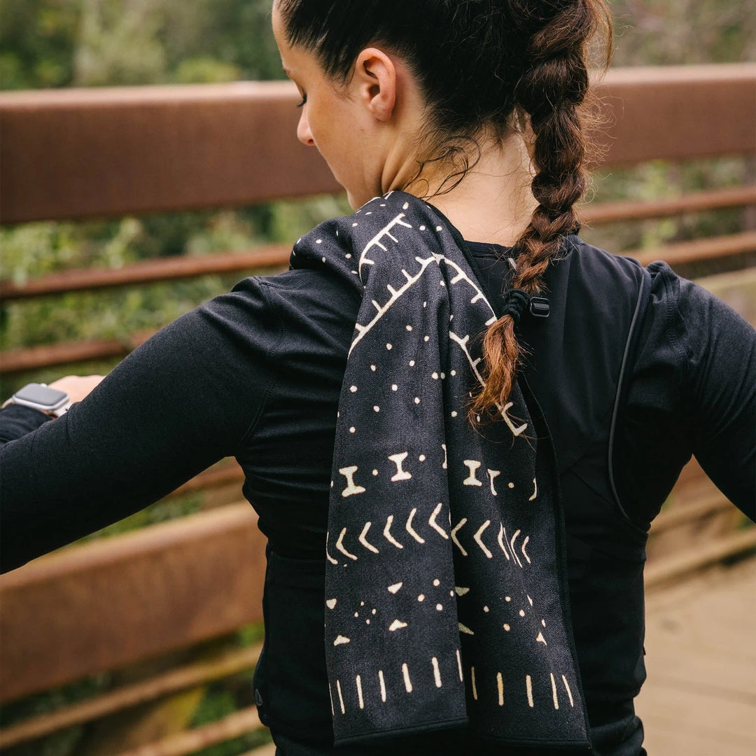 Nomadix Mud Cloth Fitness Towel on shoulder