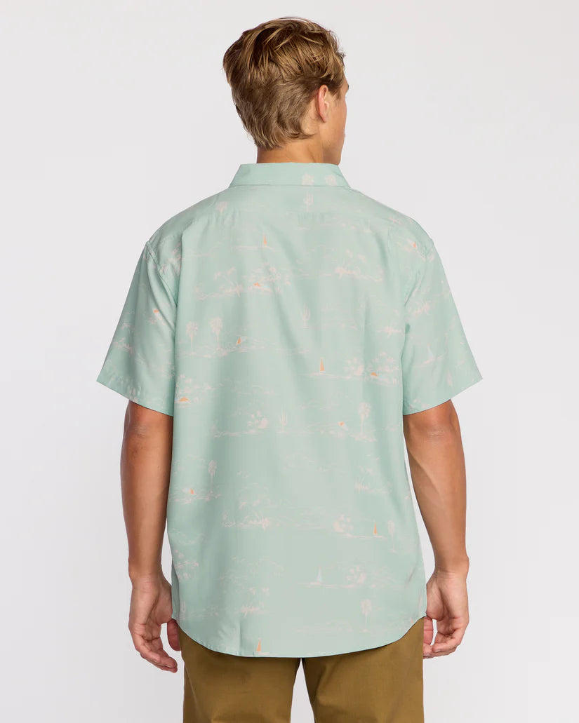 Person wearing a light green patterned shirt on a white background