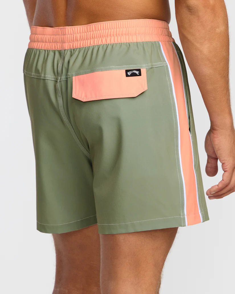 Green swim shorts with peach waistband and side stripe on a white background