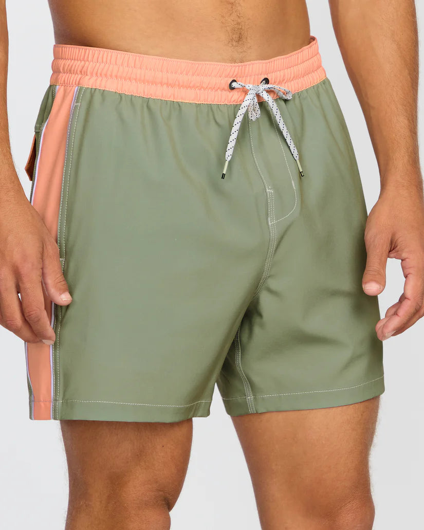 Green swim shorts with a pink waistband on a plain background