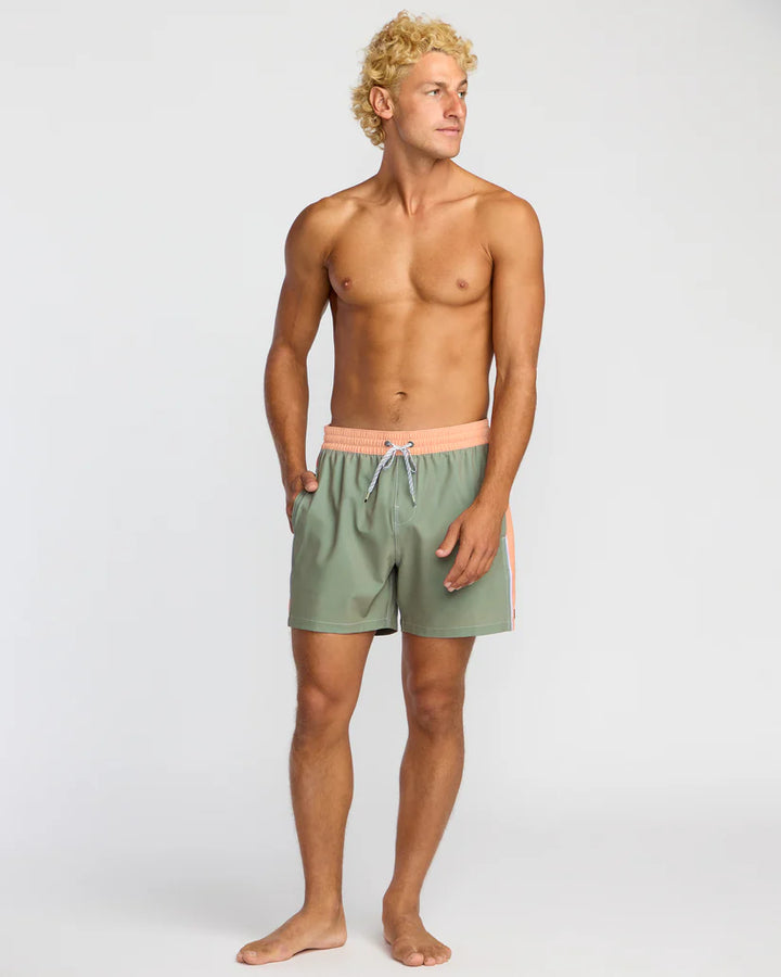 Man wearing green swim shorts on a white background