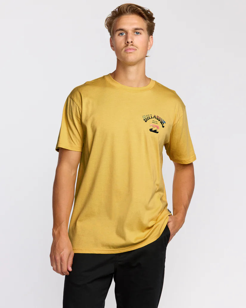 Man wearing a mustard yellow t-shirt with a logo on a white background